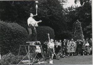 Onlookers admire a juggler’s balancing act at Gorum fair in the 1950s, found on Know Your Place Bristol (Public Relation photos info layer - BRO 40826.LEI.13.20)